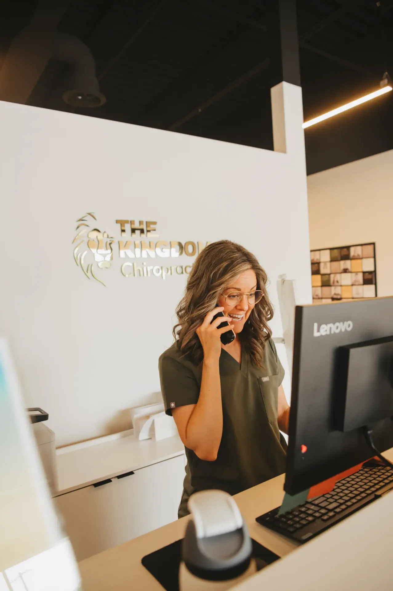 Front desk team member answering the phone at The Kingdom Chiropractic